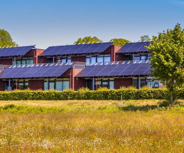 Public school building with solar panels as sun protection